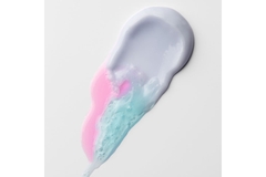 drop of creamy product next to two colored oil