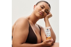 Image A woman holding a Yves Rocher body product.