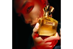 Image A man holding Scandal perfume by Jean Paul Gautier.