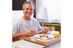 Patient in hospital bed eating a meal.
