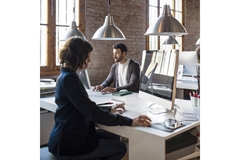 Office with people working on an online sourcing marketplace.
