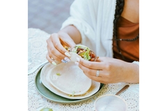 Image Woman eats tortilla.