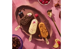 Image Three ice cream lollipops against a pink background.
