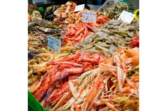 Image Different types of fresh seafood displayed in a street market.