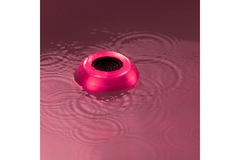Image A bath bot from Lush in pink water.