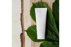 Unbranded skin care bottle on a leaf
