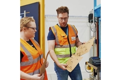 Amazon employees inspecting padded mailers.