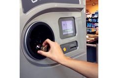 Image person returning a bottle to a reverse vending machine