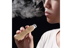 Image woman smoking Elfbar's corrugated packaging single-use vape