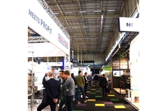 Image People walking on trade show floor.