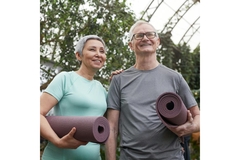 Image Older couple with yoga mats.