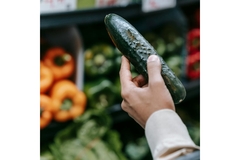 Image Buying a cucumber in supermarket.