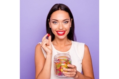 Image Woman holding gummies.