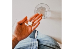 Image Woman taking pills.