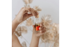 Image hands holding dropper bottle with oil