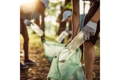 volunteers cleaning park picking up plastic bottles
