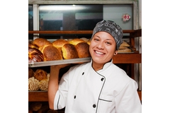Baker with tray of bread.