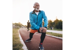 An older man stretches before a run.