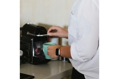 Person making coffee.