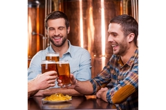 Image Two men holding glasses of beer.