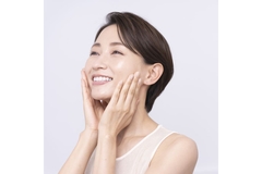 Image smiling woman touching her cheeks
