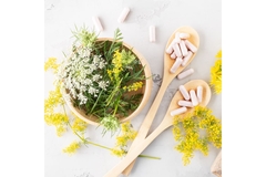 Image Several different natural ingredients and supplement capsules on a table.