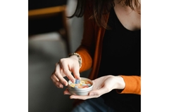 Image A woman sorting gummies in her hand.