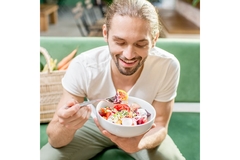 Image Man eating a vegetarian salad.