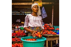Image Market merchant selling vegetables Africa