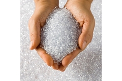 Holding plastic resins in hands.