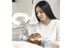 Image A dermatologist working on a clients skin.