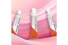Image An assortment of different makeup packaging on a pink background.