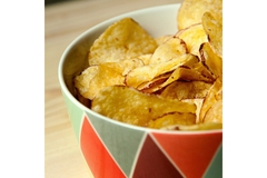 Image A colorful bowl of potato crisps.