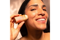 Image Smiling woman applied sun block stick on face