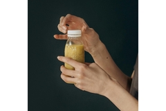 Image person uncapping a white plastic bottle cap