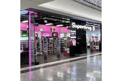 Image The outside of a Superdrug store in a mall.