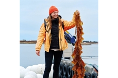 Image Woman holding seaweed.