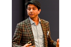 Image Tilak Thiagajaran speaking.