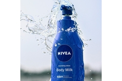 Water splashing on a Nivea body cream bottle.