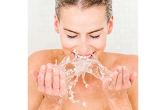 Image Woman rinses face with water