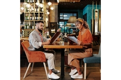 Image People sitting at a restaurant, looking at menu options.