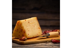 Image A cut block of cheese and a knife.