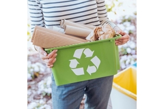 Woman carrying box with paper packaging waste.