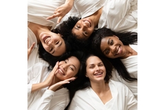 Image Diverse girls lie down in a circle smiling