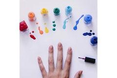 Image A hand surrounded by rainbow nail polish.
