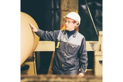 Packaging factory worker checks material.
