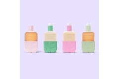 Four colorful body products in front of a purple background.