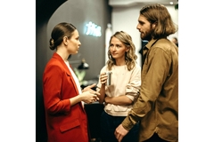 Image Three people having a discussion.