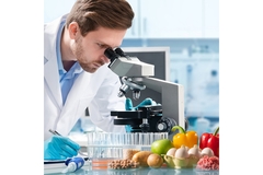 Image A male scientist looking into the microscope.
