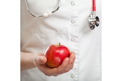 Doctor holding an apple.